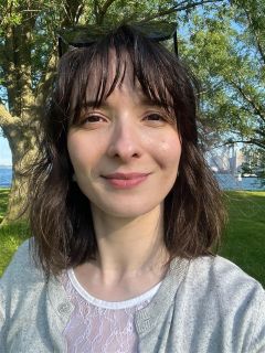 A smiling woman with short dark hair.